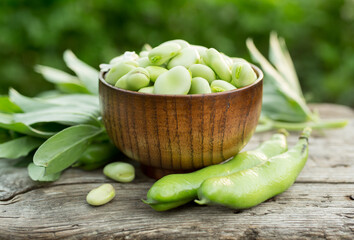 Broad beans or fava beans in a bowl. Organic diet and vegan food, Selective focus
