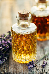 Lavender oil in bottles and fresh lavender. Shallow DOF