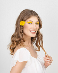 Happy smiling woman with yellow flowers in their hands - Closeup of yellow flowers, on focus