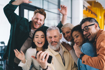 Obraz premium Happy diverse colleagues recording video during workday