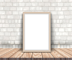 3D render of a blank picture frame on a wooden table leaning against a brick wall