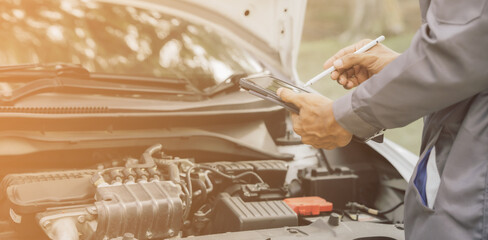 Obraz premium Automobile mechanic repairman hands repairing a car engine automotive workshop with a wrench, car service and maintenance,Repair service.