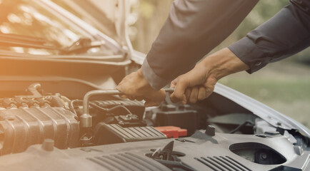 Automobile mechanic repairman hands repairing a car engine automotive workshop with a wrench, car service and maintenance,Repair service.