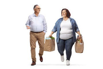 Overweight woman carrying grocery bags walking and talking to a mature man