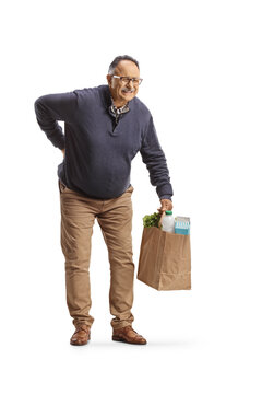 Mature man with a stiff back holding a grocery bag