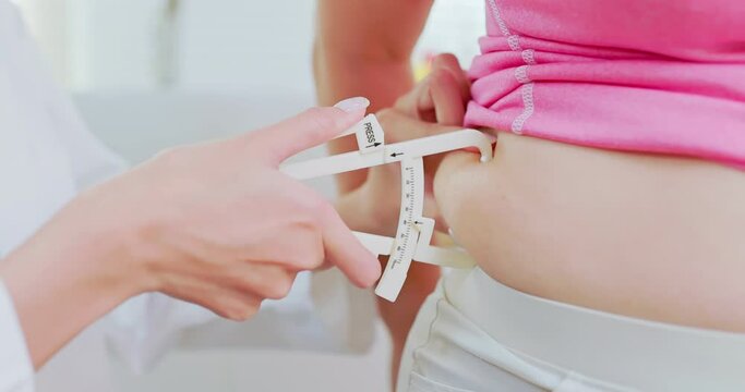 physician measure woman waist