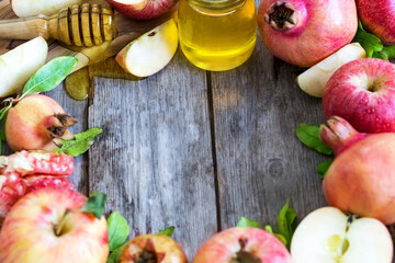 Apples, pomegranate and honey - symbols of judaic holiday Rosh Hashana (Jewish New Year). Selective focus. Copyspace background.