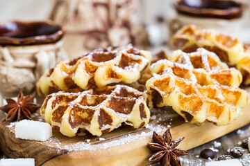 Homemade liege belgian waffers with sugar pearls and coffee on old wooden background