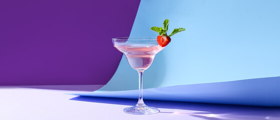 Glass of tasty cosmopolitan cocktail on color background