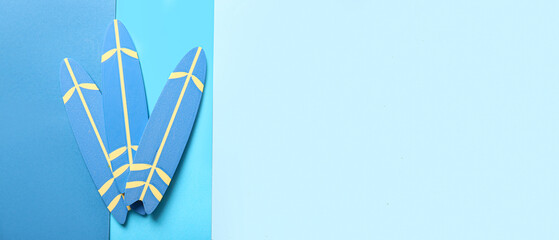 Small surfboards on blue background with space for text