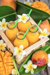 Fresh mango juice in small bottles in wooden box