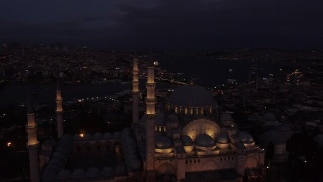 Aerial view of the glowing Blue Mosque in Istanbul at night. Smooth drone flight in big muslim city. 4k footage.