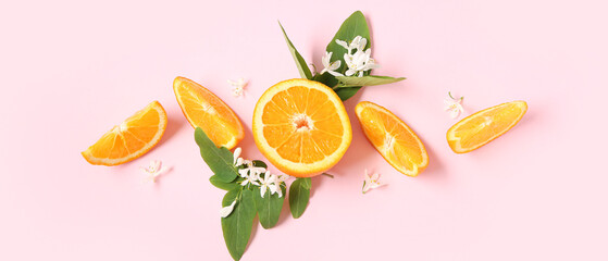 Orange pieces with blooming branches on pink background