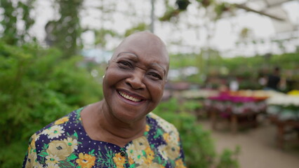 Portrait of a Brazilian older woman close-up face looking at camera standing inside a Green Environment