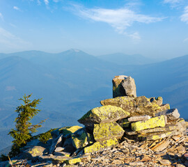 Stony piles on summer morning Carpathian mountain top. View from stony summit of Ihrovets Mount (Gorgany, Ukraine).