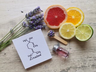 Structural chemical formula of linalool with fresh lavender flowers and citrus fruit. Linalool is...