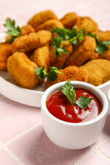 Bowl with tasty ketchup on pink tile background