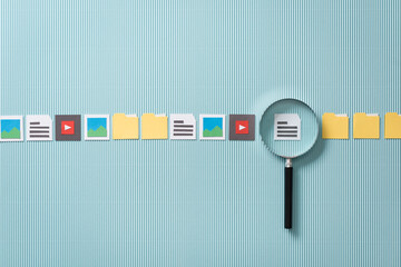 File search, scan and analysis: magnifier zooming in on a file, paper cut icons