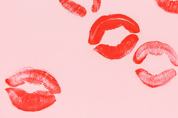 Red lipstick kiss marks on pink background