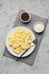 Composition with plate of scrambled eggs on grunge background