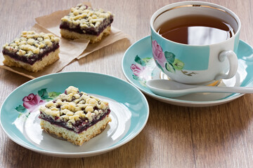 Homemade black currant crumble pie bars and cup tea