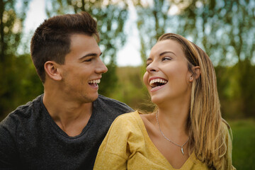 Fototapeta premium Portrait of a young beautiful couple laughing