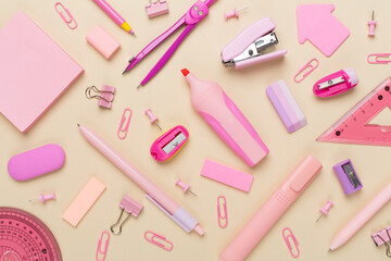 Pink school stationery on color backgroung, top view