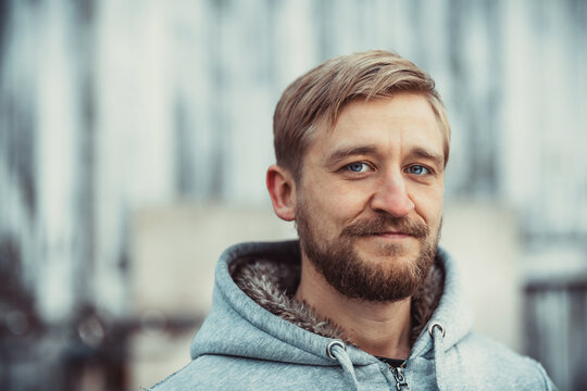 Young man with a beard and mustache outdoor portrait