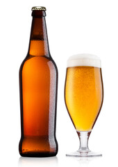 Cold bottle and glass of lager beer with foam and dew isolated on white background