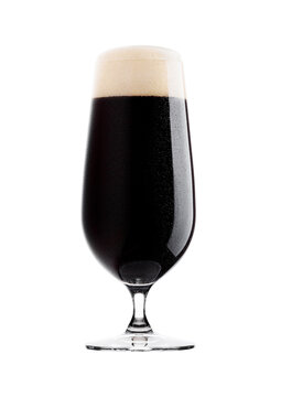 Cold glass of dark beer with foam and dew on white background with reflection