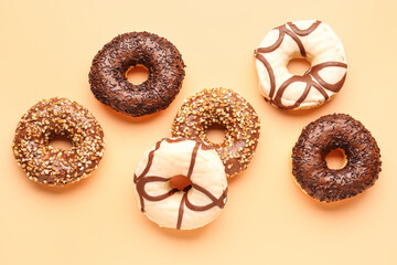 Sweet chocolate donuts on beige background