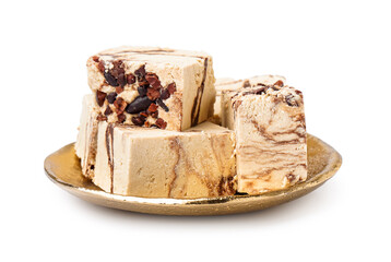Plate with pieces of tasty marble halva on white background