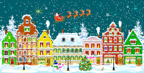 City street in the winter night. Christmas Eve. Winter holiday. Houses in winter night. Snow on a city street. Decoration houses on winter holidays.