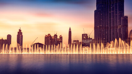 Fototapeta na wymiar Musical fountain of Dubai, amazing beautiful fountain glowing at night, world famous tourist attraction, traveling to UAE