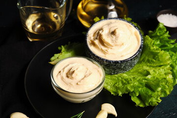 Bowls of tasty cream cheese on dark background