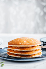 Fresh American Pancakes on blue plate and white background