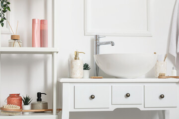 Fototapeta na wymiar Sink bowl with bath accessories on table in bathroom
