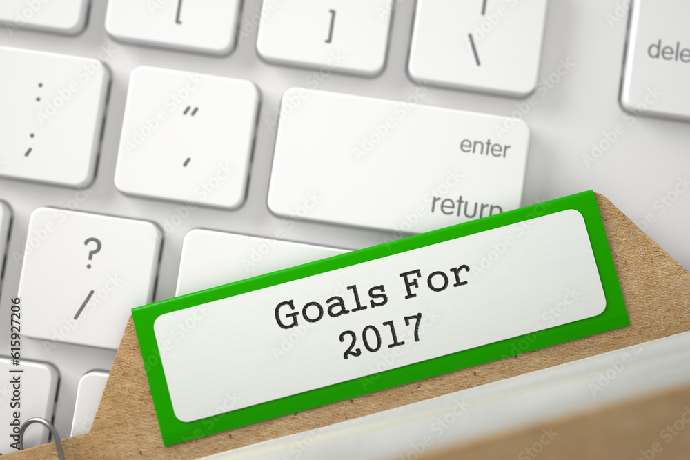 Poster goals for 2017 written on green card index on background of white modern keypad. closeup view. selec