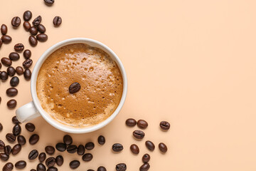 Cup of hot espresso and coffee beans on beige background