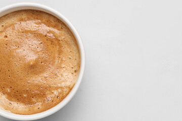 Cup of hot espresso on grey background