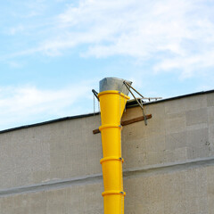 Debris chute, removing debris and waste from roof of the building. Plastic garbage chute against...