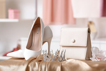 Tiara with bag and heels on prom dress in boutique, closeup