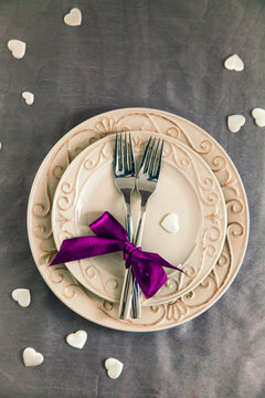 Valentines day table. Plate with two forks and hearts. Valentine's day dinner.St. Valentine table setting