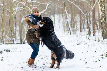 Fototapeta na wymiar Big Dog hugging his mom on a winter day with snow