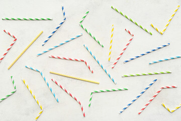 Different paper drinking straws on white background