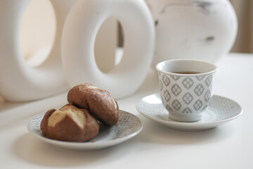 chocolate cookies and tea cup on table 