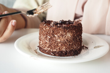 chocolate and cream cake on a plate on table 