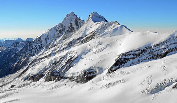 high snowy mountain peaks and glaciers rocks with blue sky, freedom