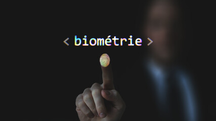 On a foreground a fingerprint scanning with the French text biometric. In the background a blur silhouette, identity check, identity control by a finger print, uniqueness, peculiarity, unique, check.