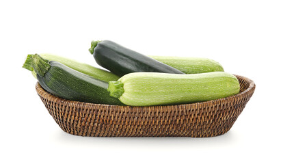 Wicker bowl with fresh green zucchini on white background